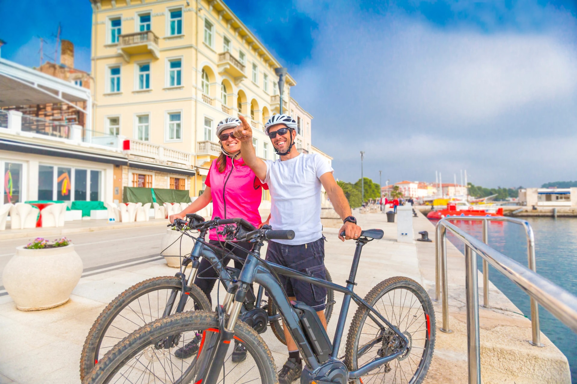 Pärchen mit dem E-Bike im Urlaub im Süden