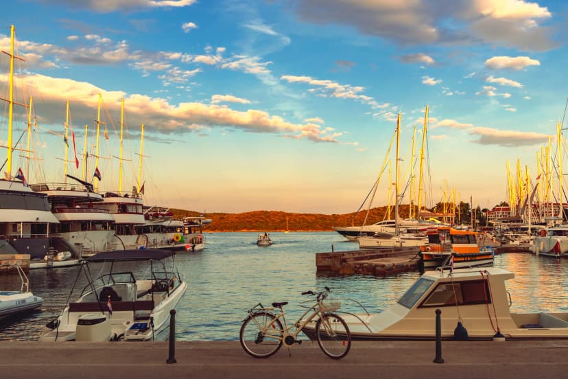 Beautiful viiew of marina with boats and bicycle at sunset, Korcula, Croatia