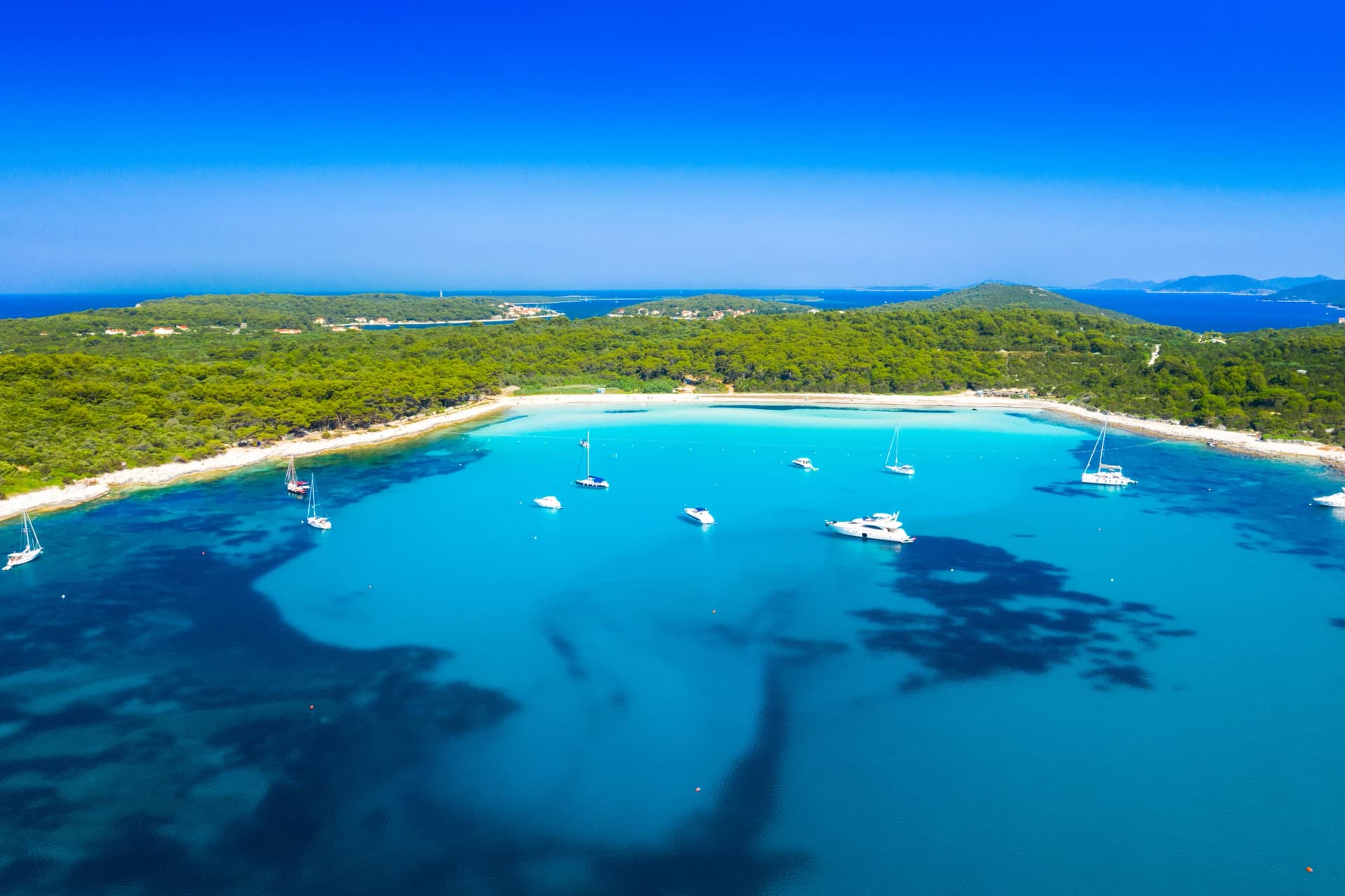 Aerial view of sailing boats in a beautiful azure turquoise lagoon on Sakarun beach on Dugi Otok island, Croatia, beautiful seascape