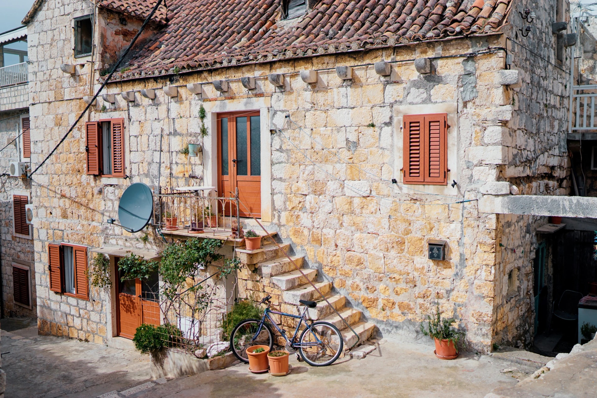 Ancient stone building with tiled roof in Hvar old town, Croatia.