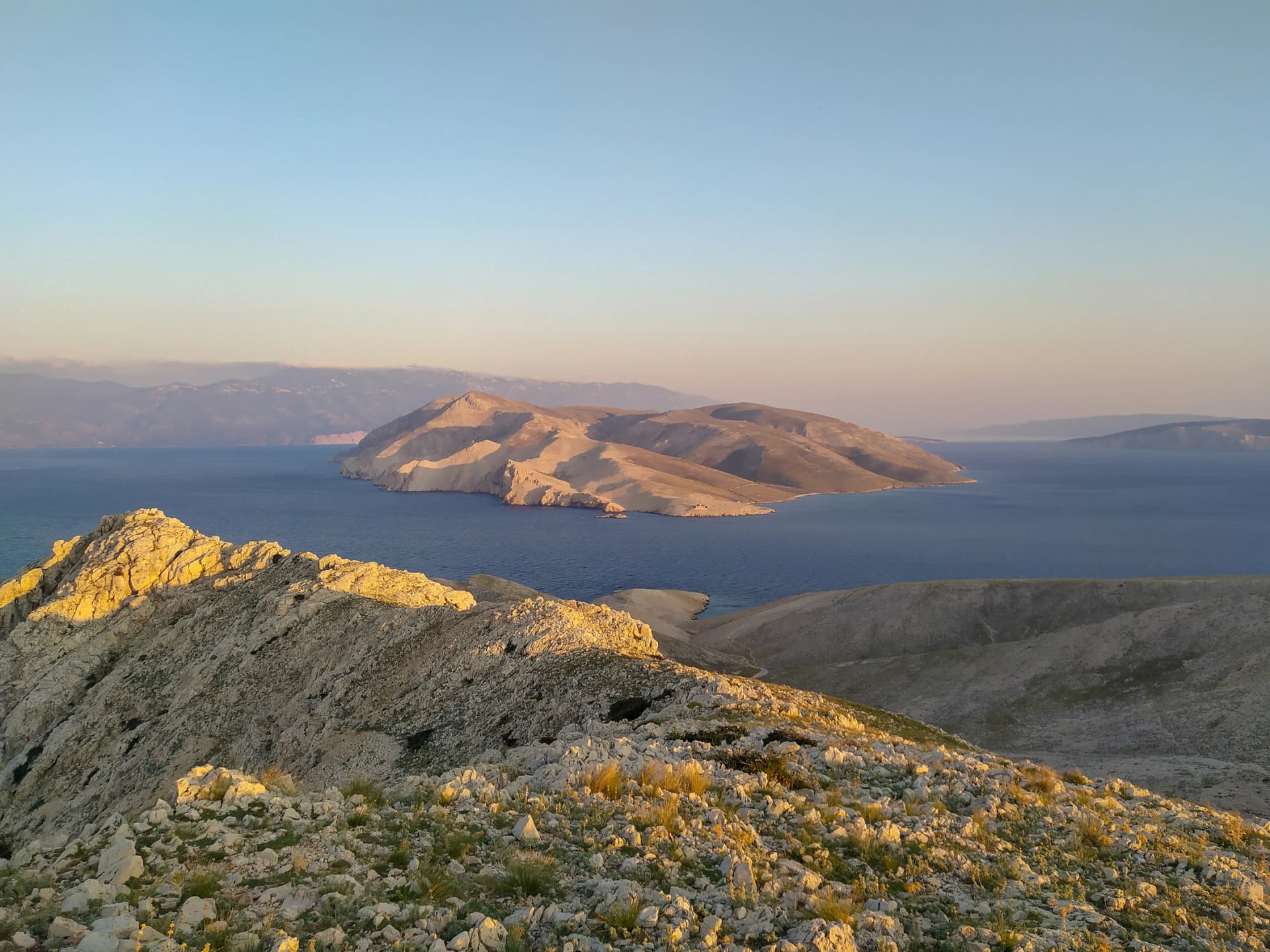 view on Prvic island from island Krk and mountain hiking and cycling trail on island Krk in sunset