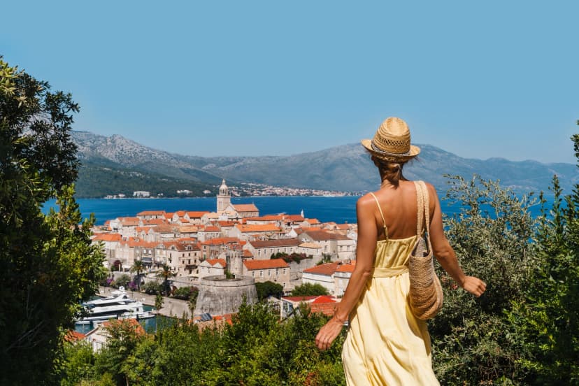Female tourist enjoying summer vacation in Croatia, Korcula Island, Korcula Town.