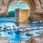 Dubrovnik scenery. / Old stone hole with Dubrovnik scenery in background, croatian travel places.